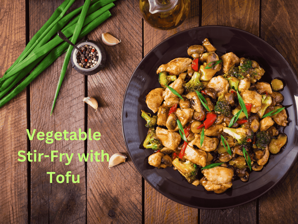 Tofu and vegetables stir-fried with sesame oil in a skillet.